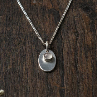 Sterling silver necklace with an 11 mm stone pendant and flower design