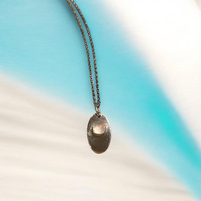 Sterling silver necklace with an 11 mm stone pendant and flower design