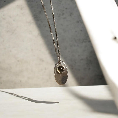 Sterling silver necklace with an 11 mm stone pendant and flower design