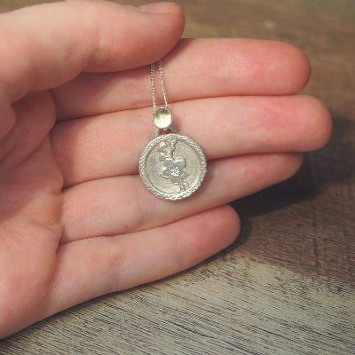 collier pour femme en argent fleur de cerisier en citrine sur une main